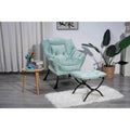 Fauteuil capitonné vert avec poche latérale
