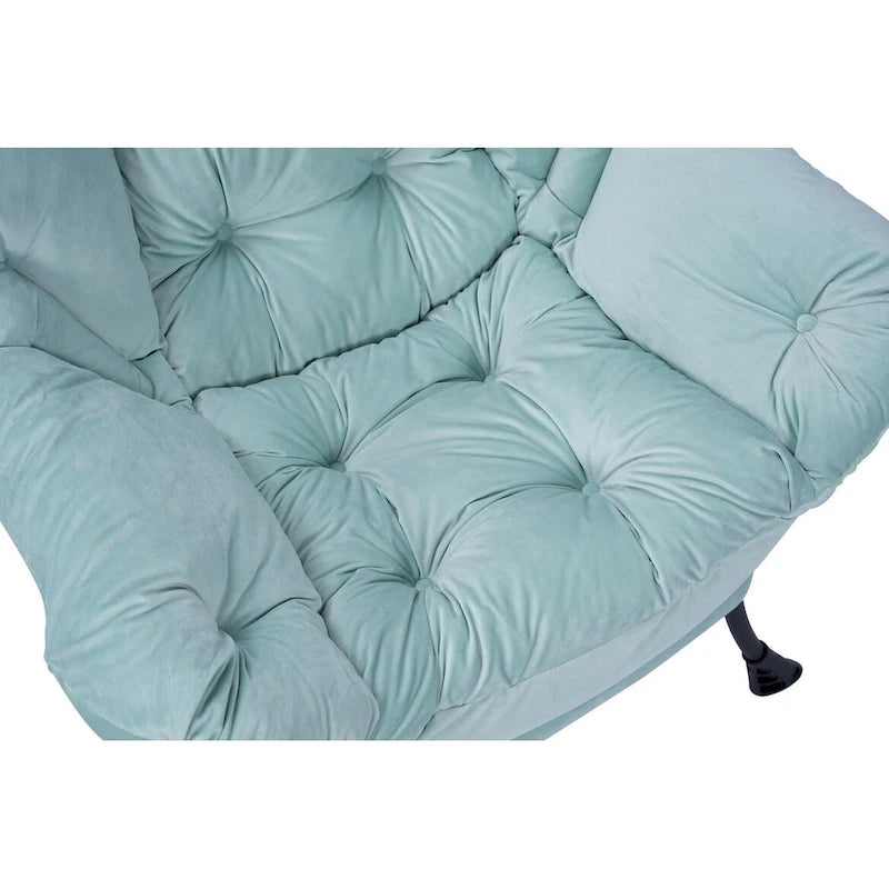 Fauteuil capitonné vert avec poche latérale