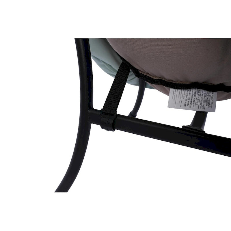 Fauteuil capitonné vert avec poche latérale